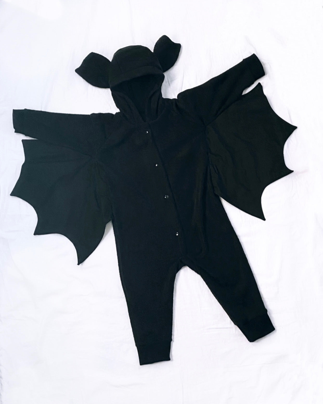 Black baby romper with bat wings on a white background