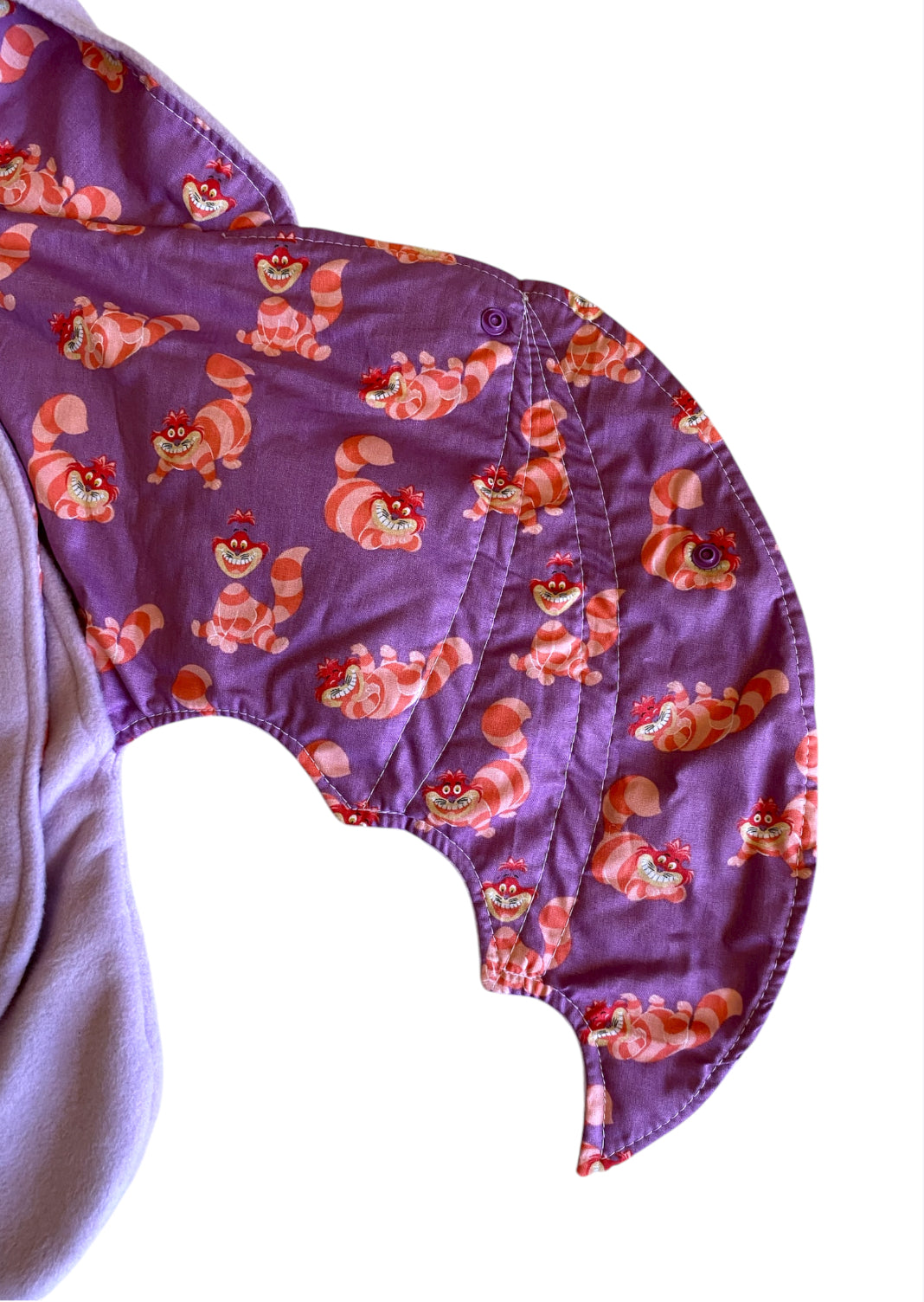 Purple fabric with cartoon character pattern on a white background