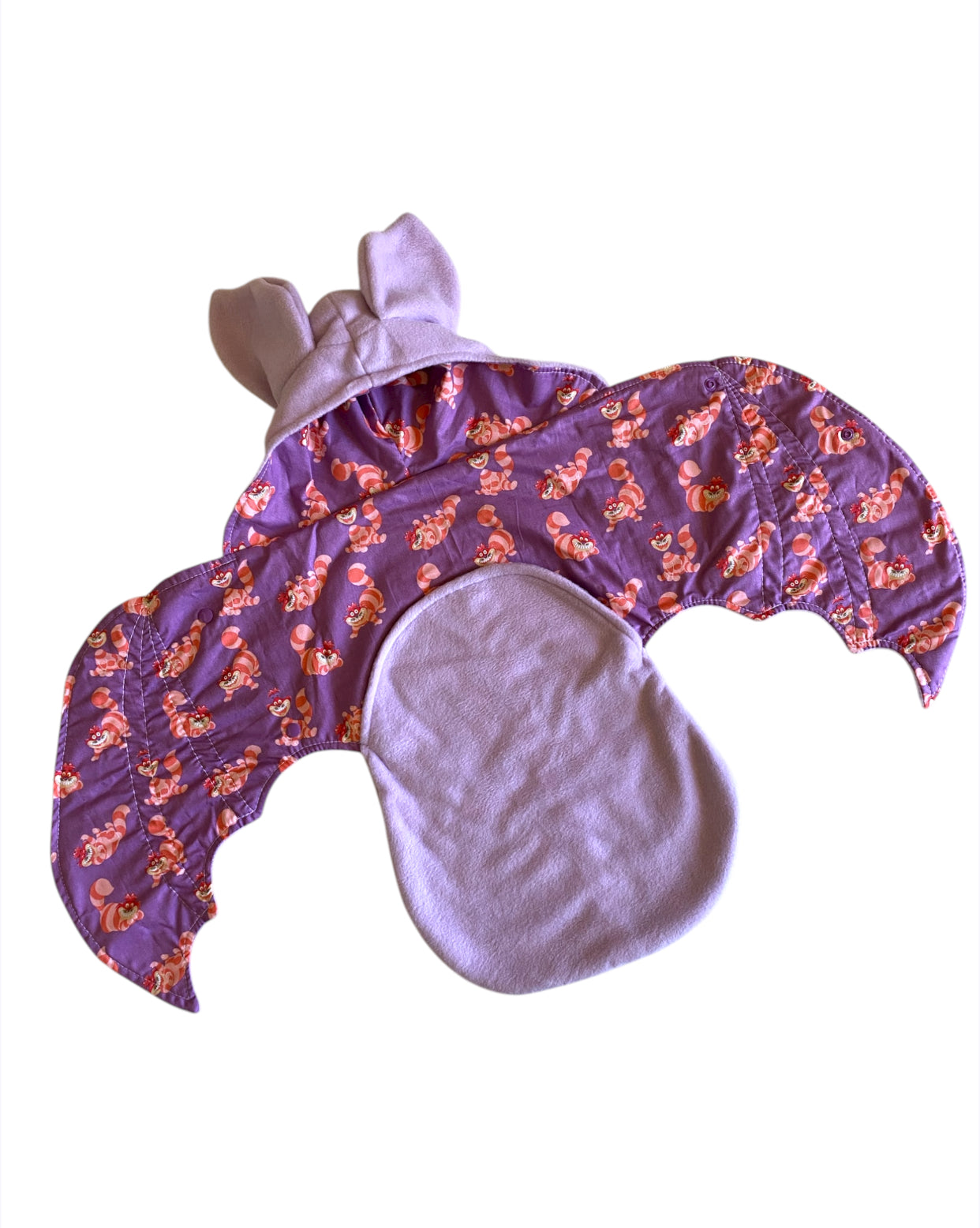 Purple baby outfit with Cheshire Cat pattern and bat ears on a white background