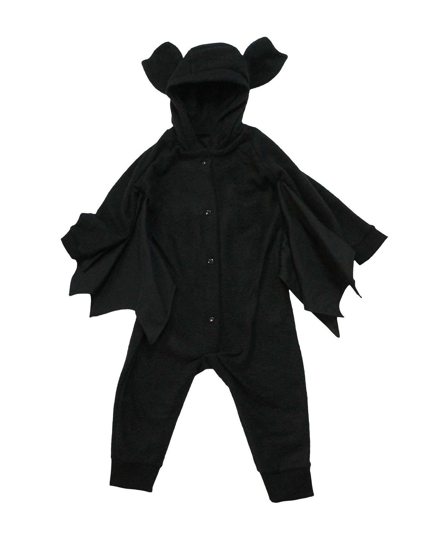Black bat-themed baby outfit with cape and ears on a white background