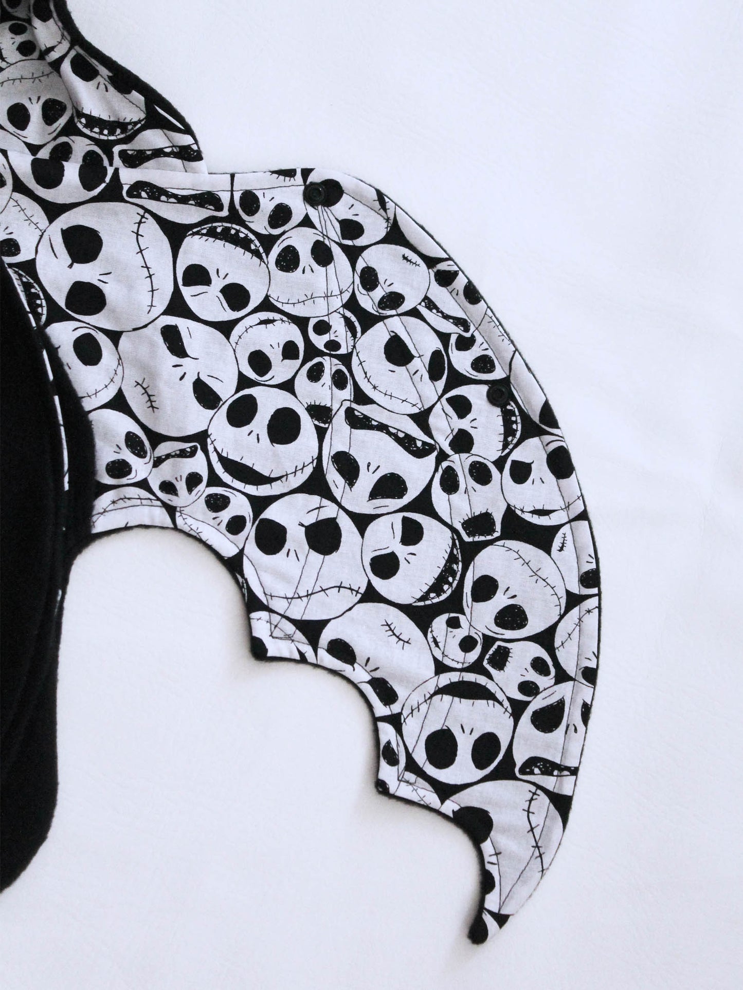 Black and white skull patterned bat wing on a white background