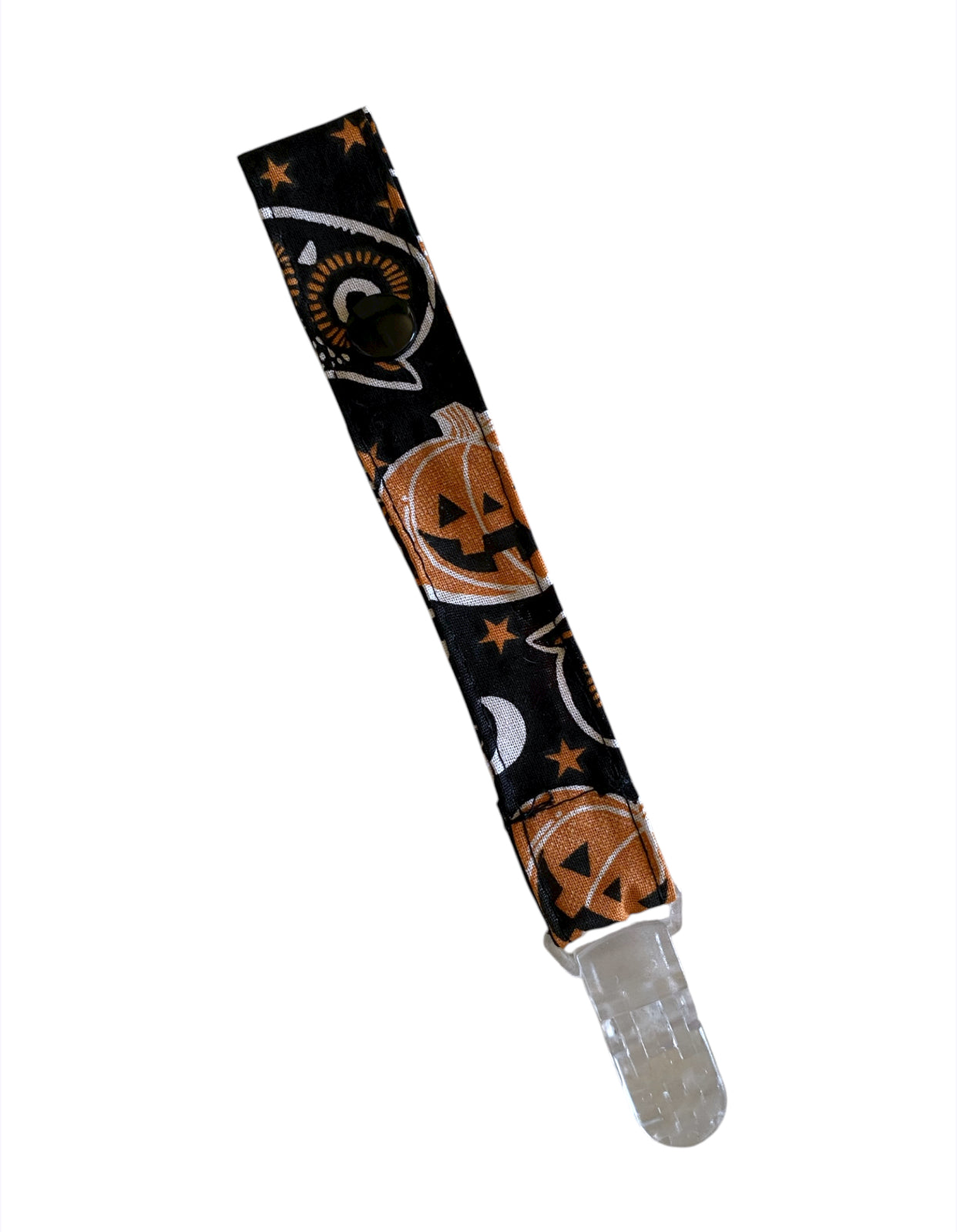Pacifier clip with Halloween design featuring pumpkins and ghosts on a black background.