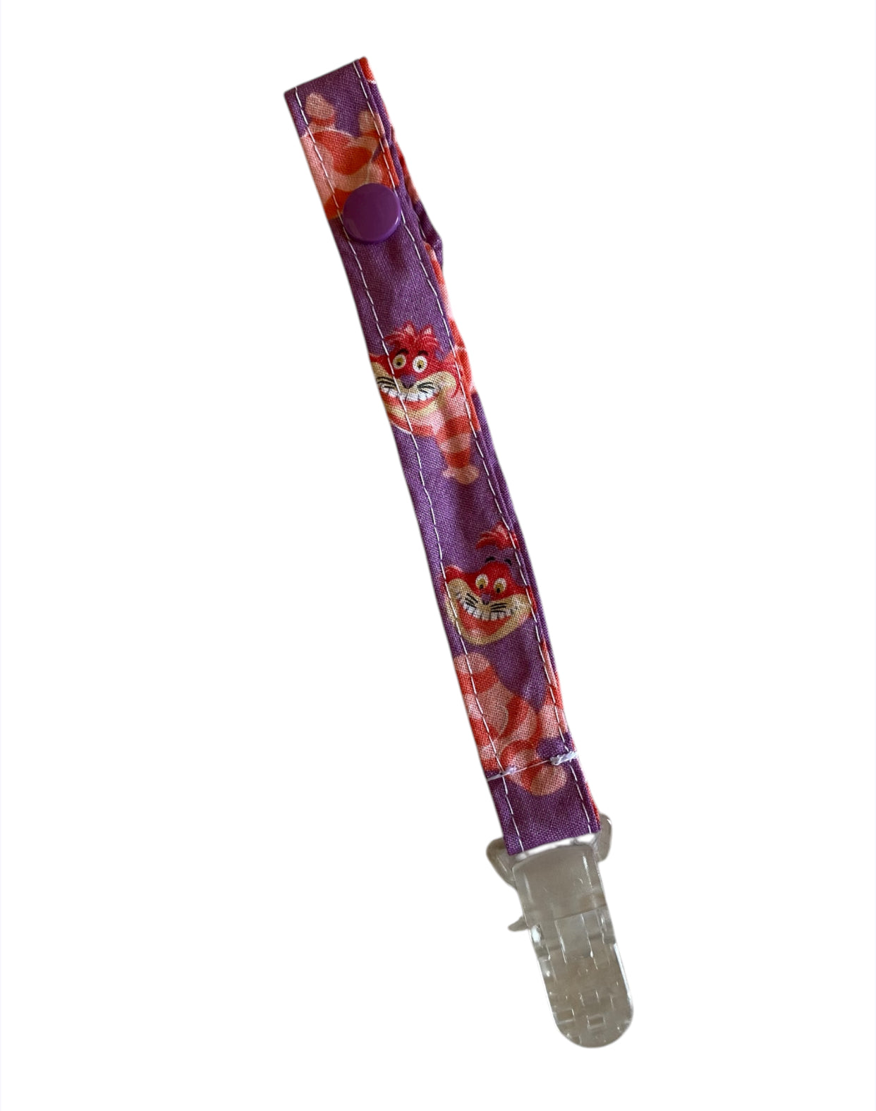 Purple pacifier clip with cartoon character design on a white background