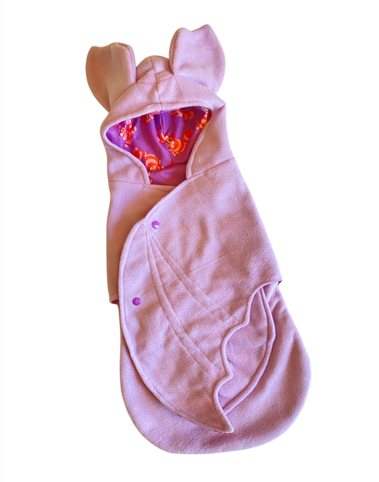 Pink Cheshire Cat baby swaddle with hood and ears on a white background