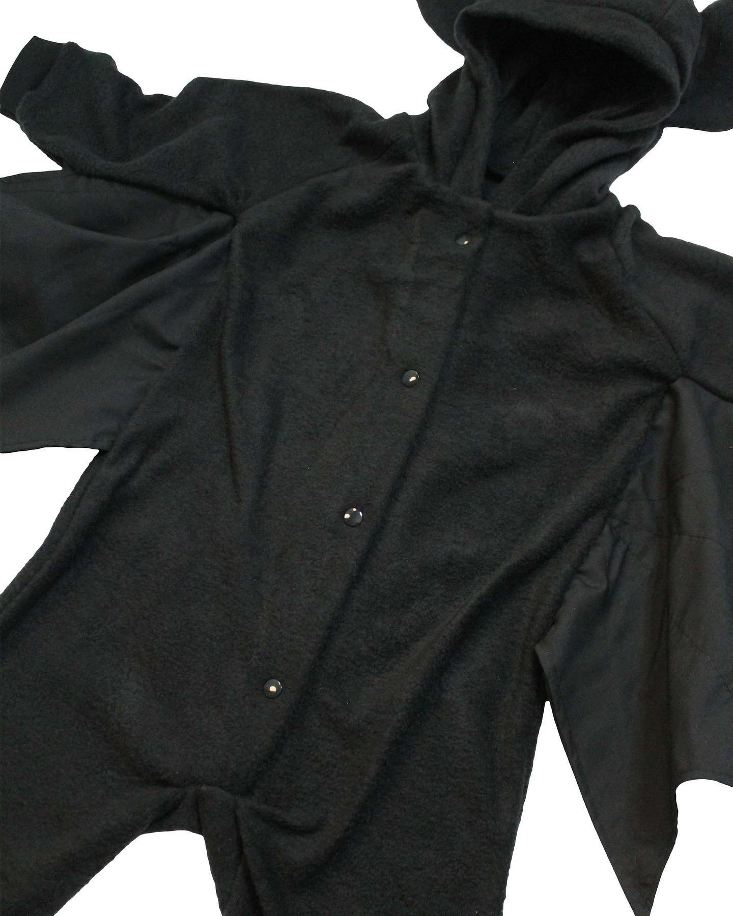 Black baby onesie with long sleeves and buttons on a white background