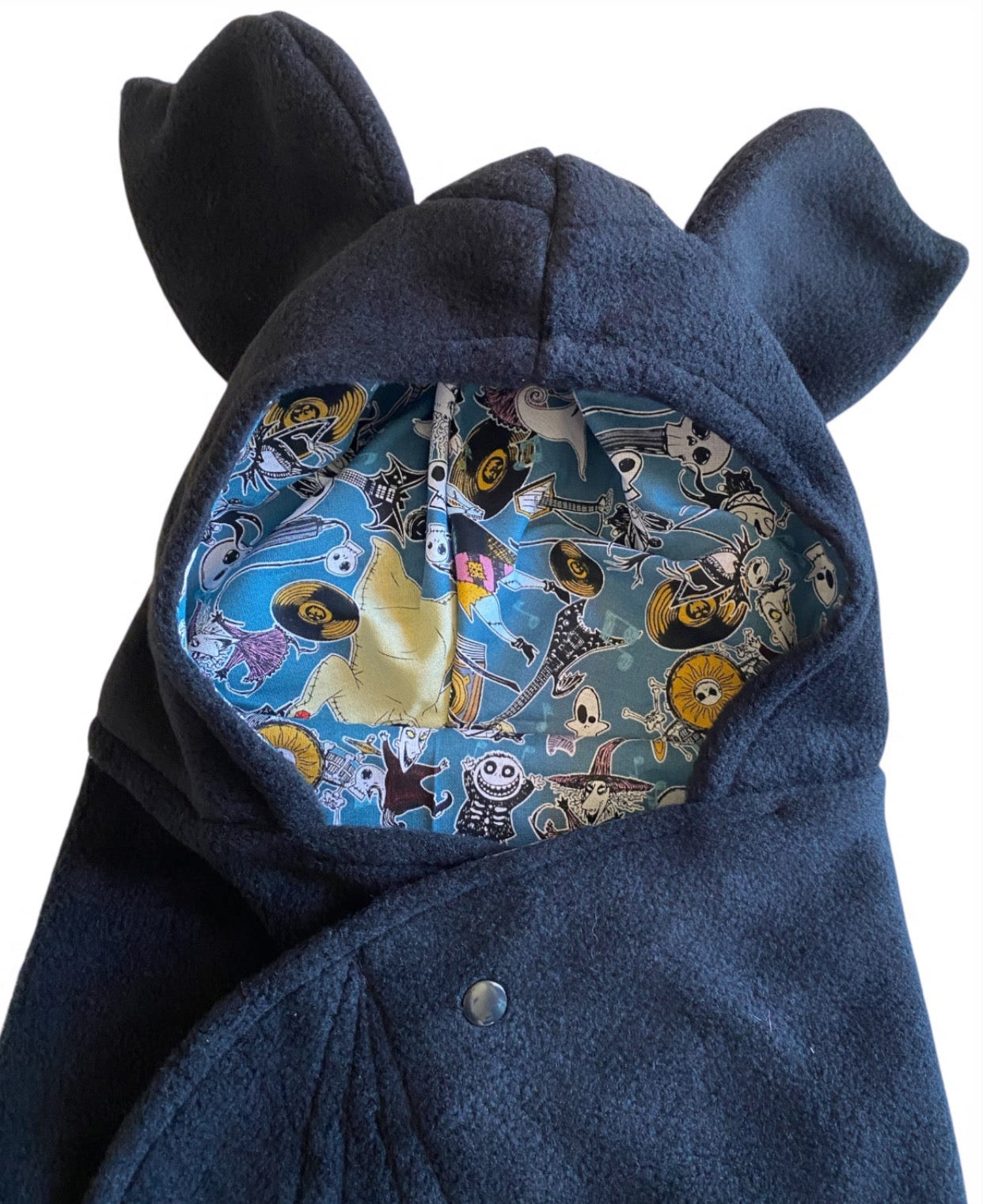 black and teal hooded garment with animal pattern on a white background