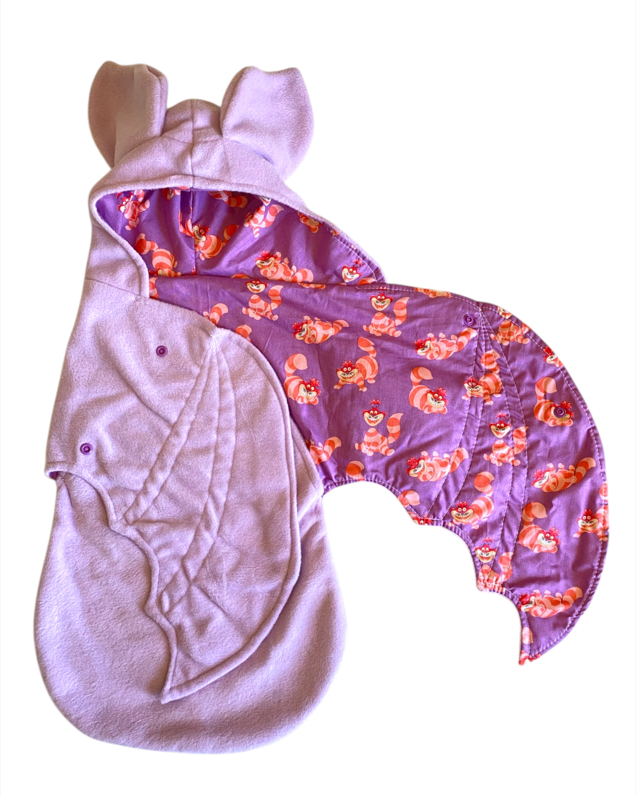 Purple baby wrap with Cheshire Cat pattern on a white background