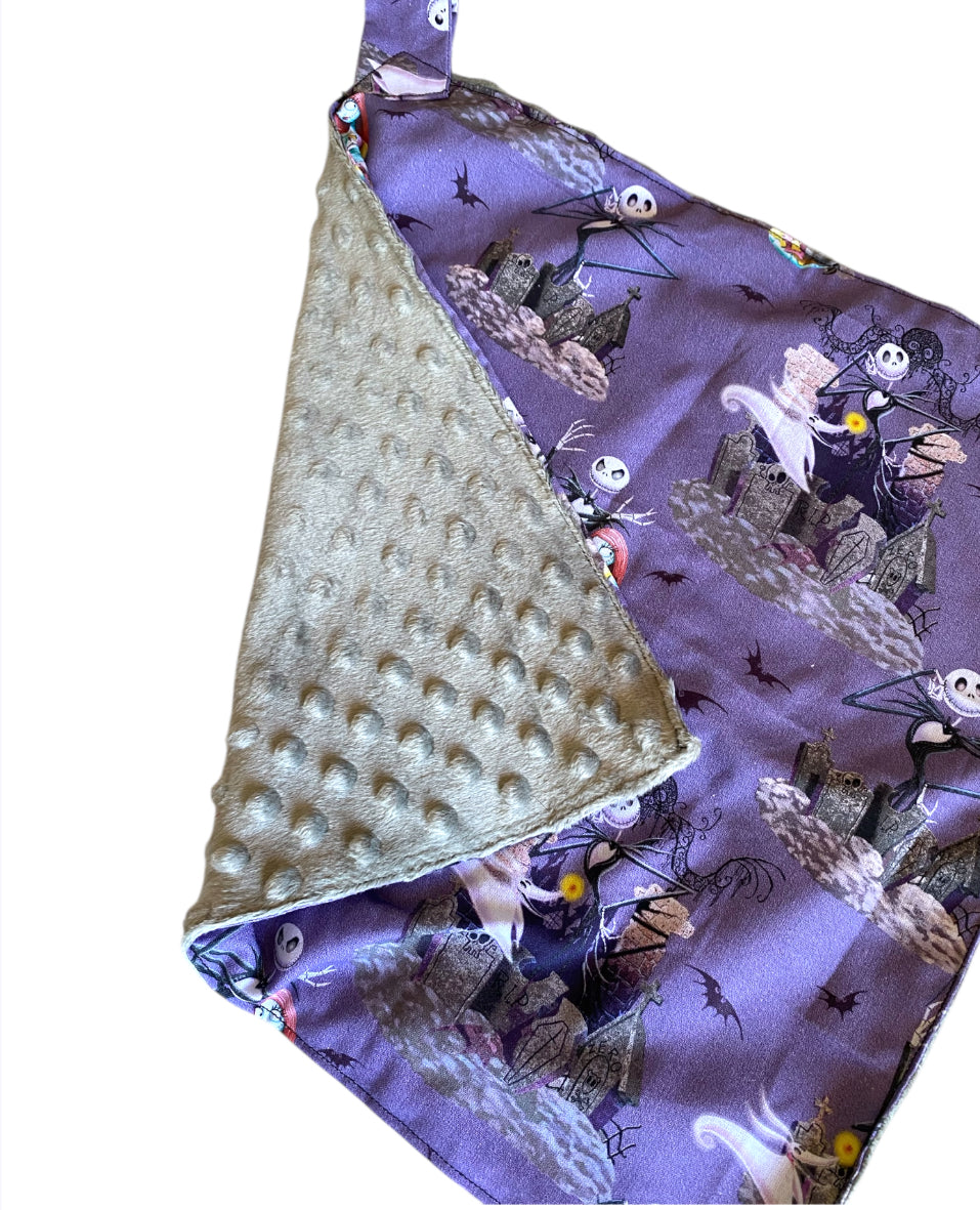 Baby blanket with purple Halloween-themed design and textured gold side