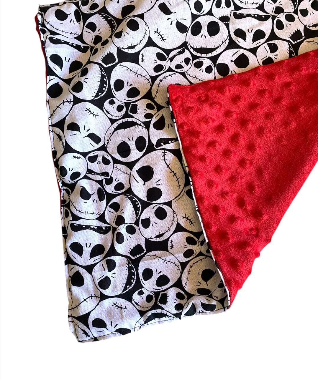 Two fabric swatches, one with skull pattern and the other red, on a white background.
