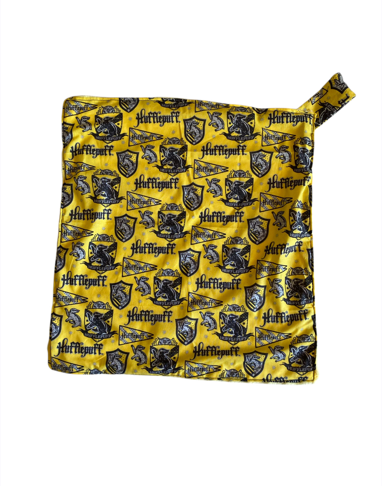 Folded fabric with Hufflepuff logo pattern on a yellow background