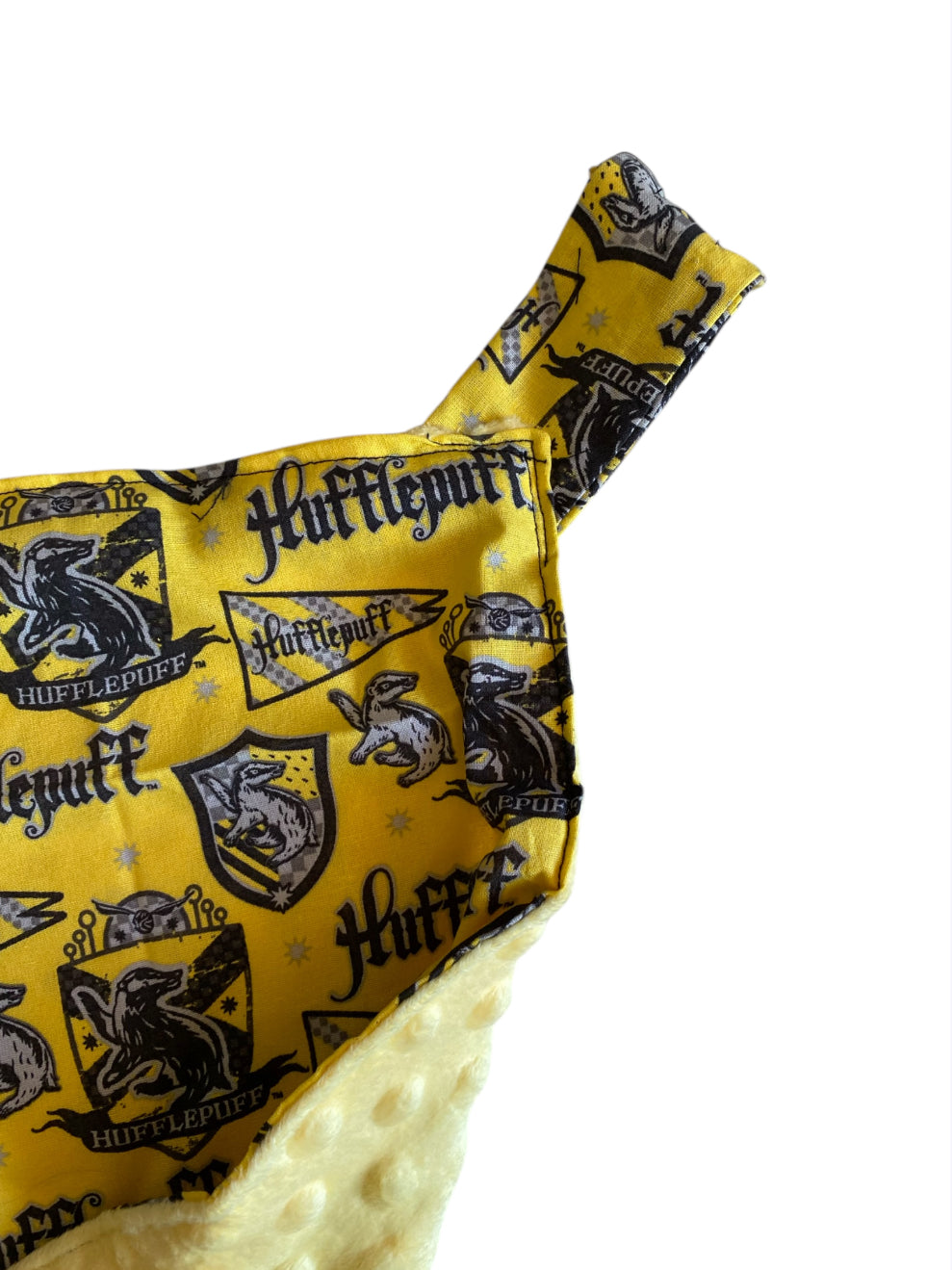 Hufflepuff-themed fabric with yellow and black colors on a white background