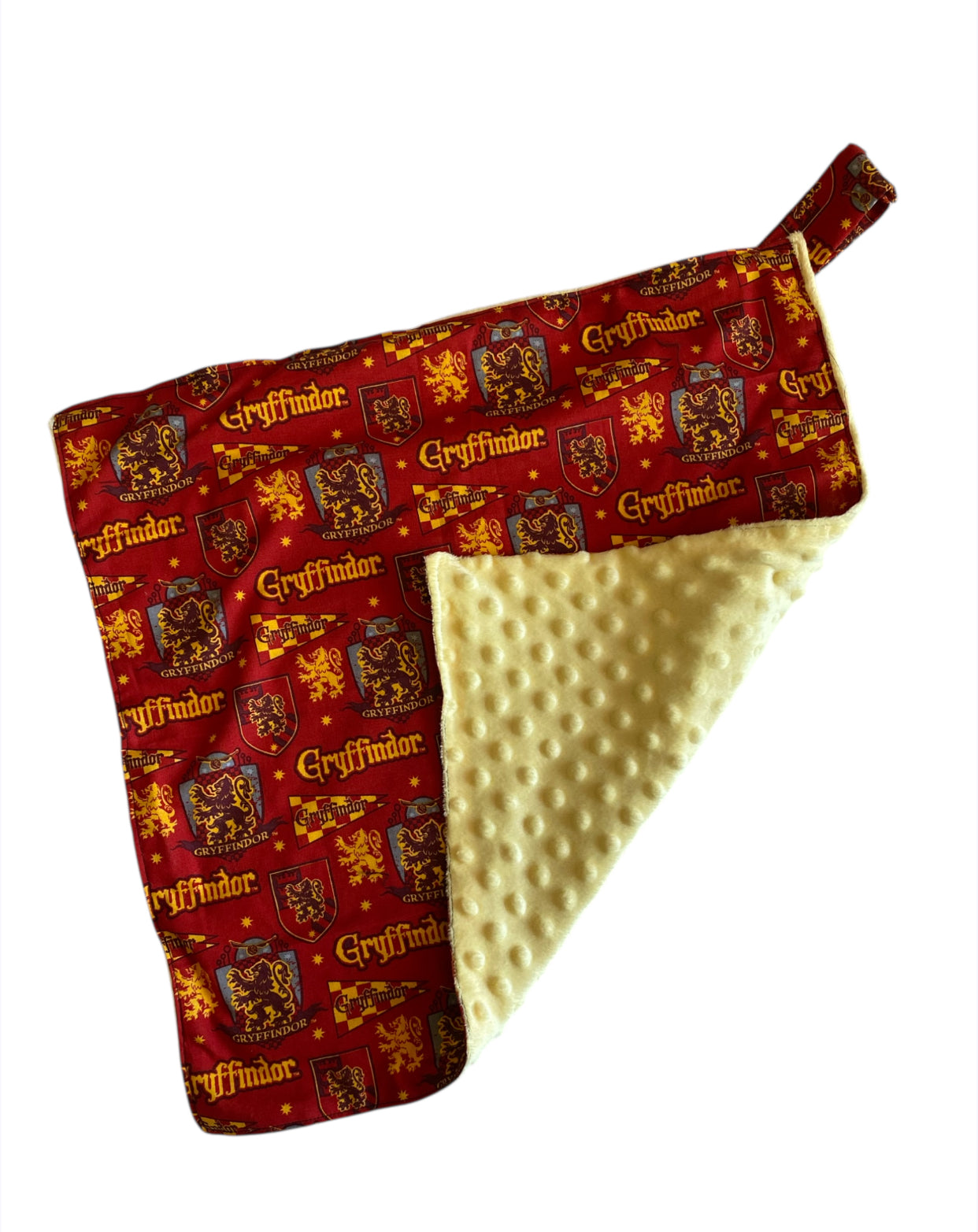 Baby blanket with Gryffindor pattern on one side and textured yellow fabric on the other, on a white background.