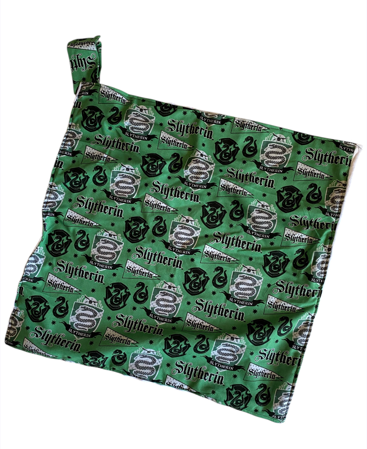 Fabric with Slytherin crest pattern on a green background