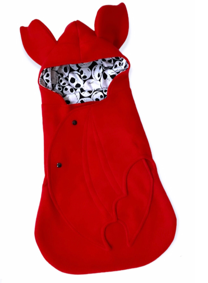 Red bat costume with skull pattern inside on a white background