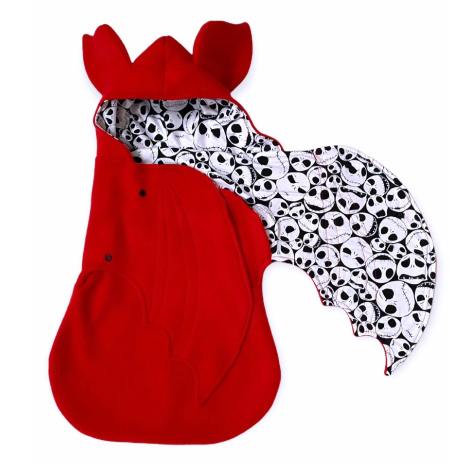 Red hooded garment with skull pattern on a white background