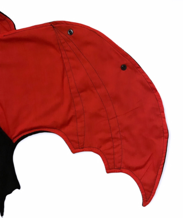 Red fabric bat wing with black on a white background