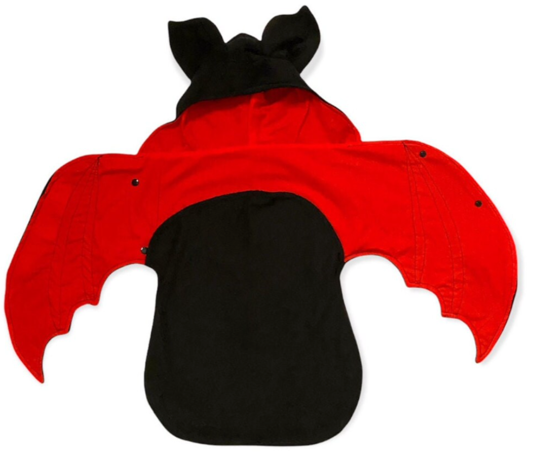 Red and black baby costume with bat ears on a white background