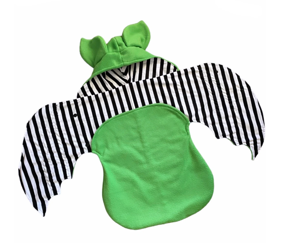 Green and black striped baby outfit with a hood on a white background