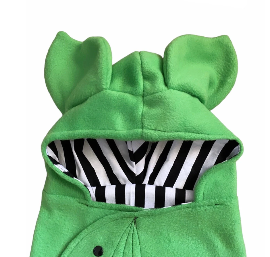 Green hooded outfit with animal ears and black and white striped lining on a white background