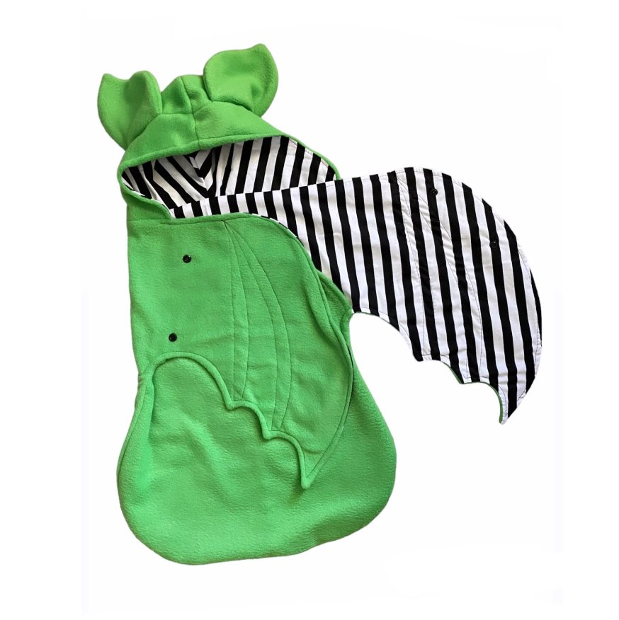 Green baby costume with black and white striped shirt on a white background