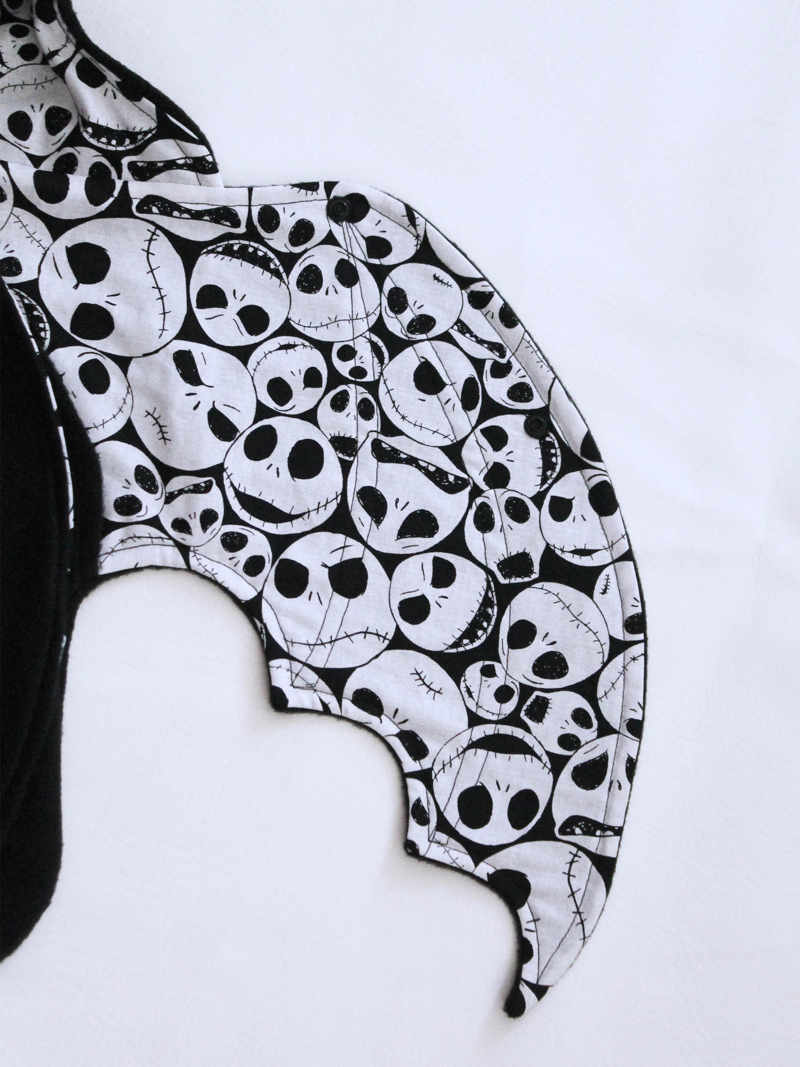 Black and white skull patterned bat wing on a white background