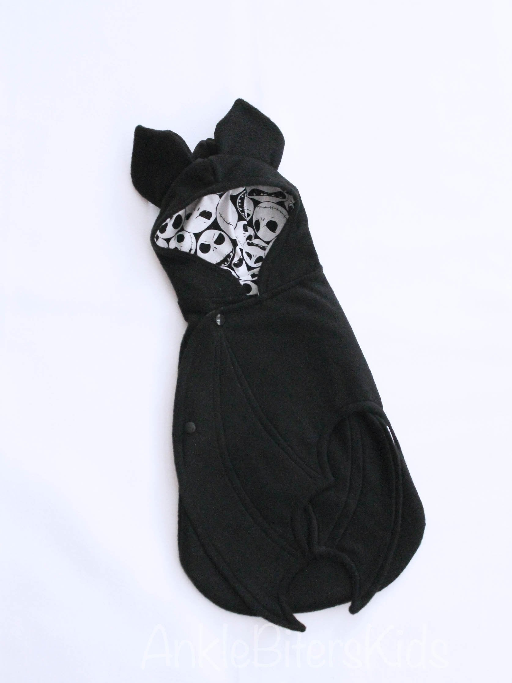 Black baby swaddle with skull pattern on a white background