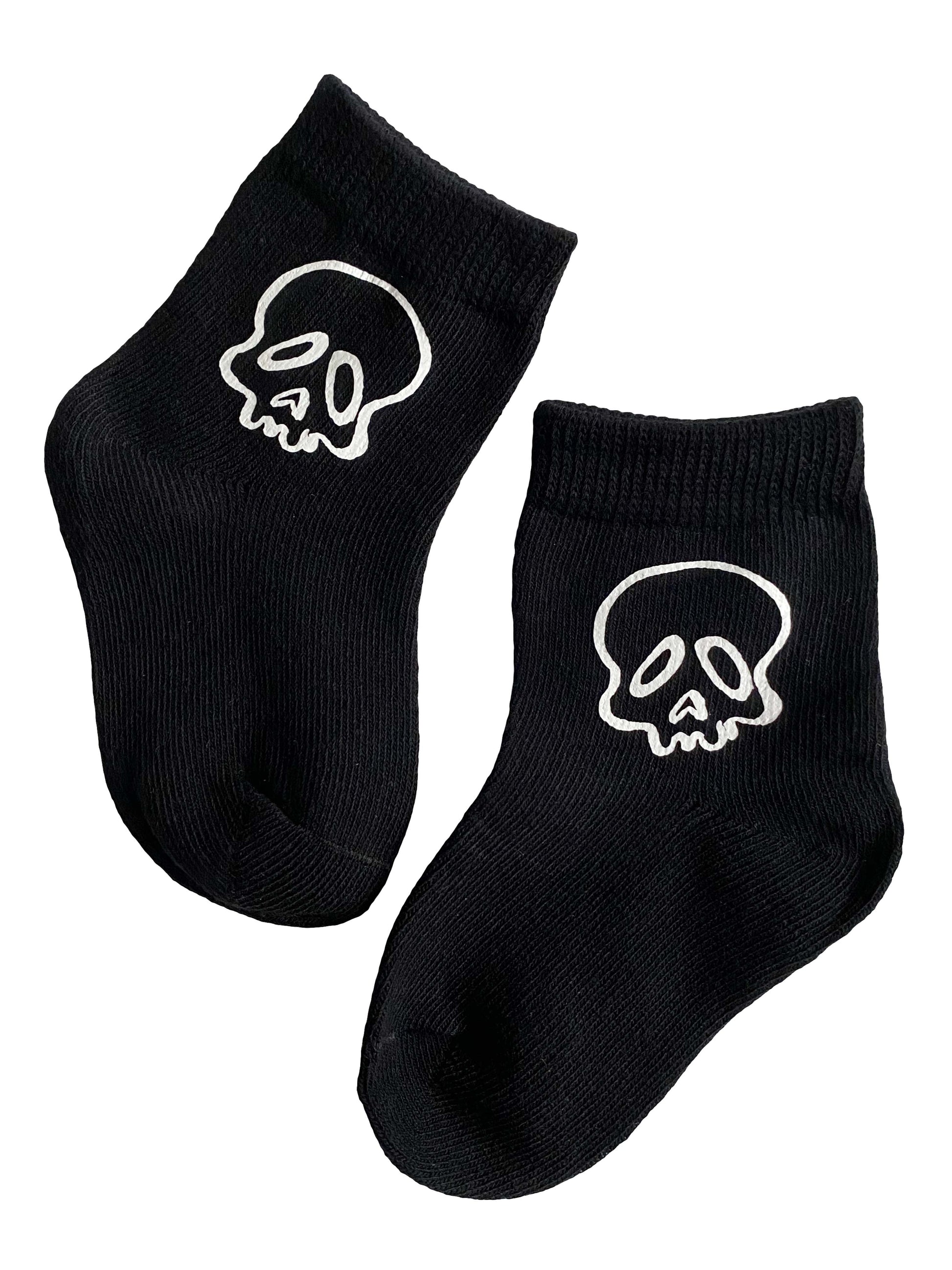 Black socks with white skull designs on a white background