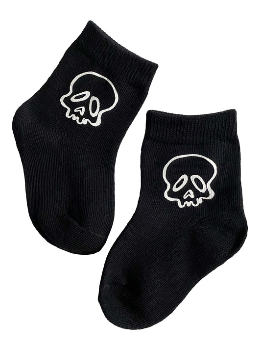 Black socks with white skull designs on a white background